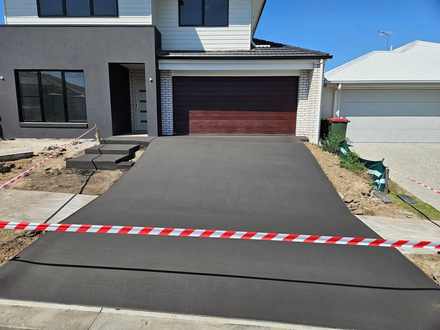Charcoal concrete driveway by JRB
