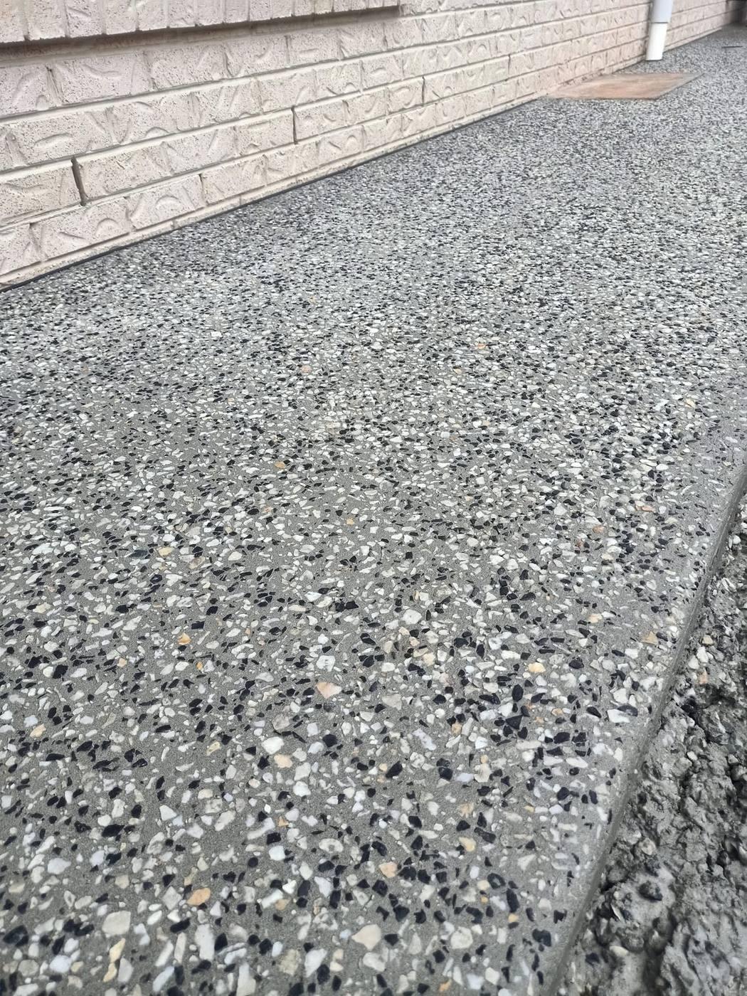 Exposed aggregate driveway, double garage home