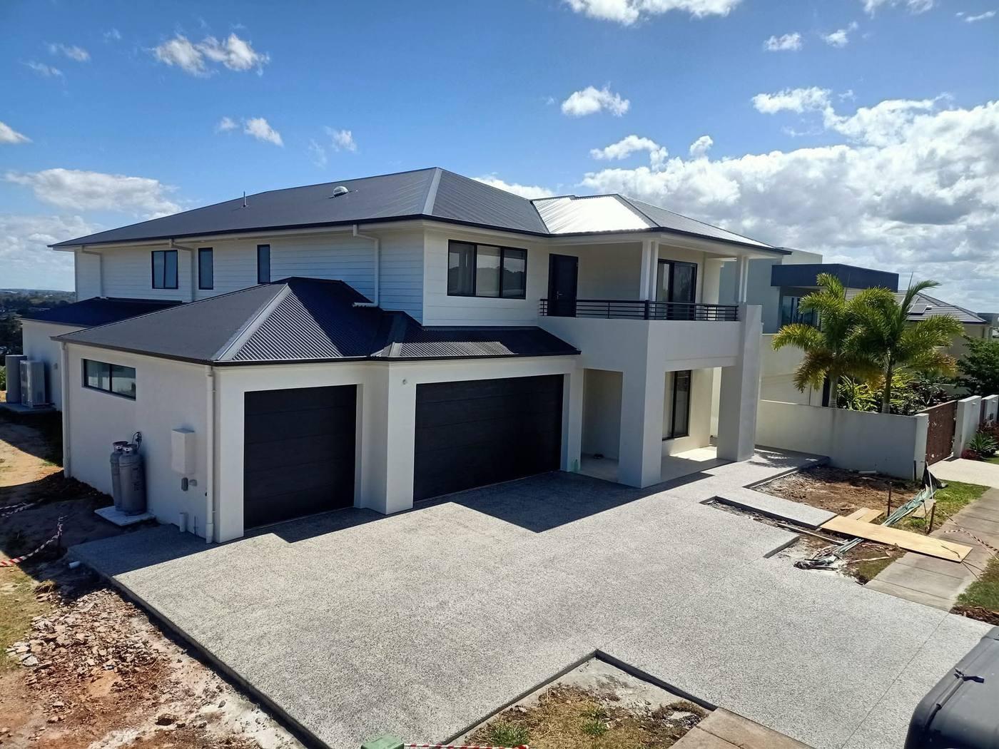 Exposed aggregate driveway, double garage home