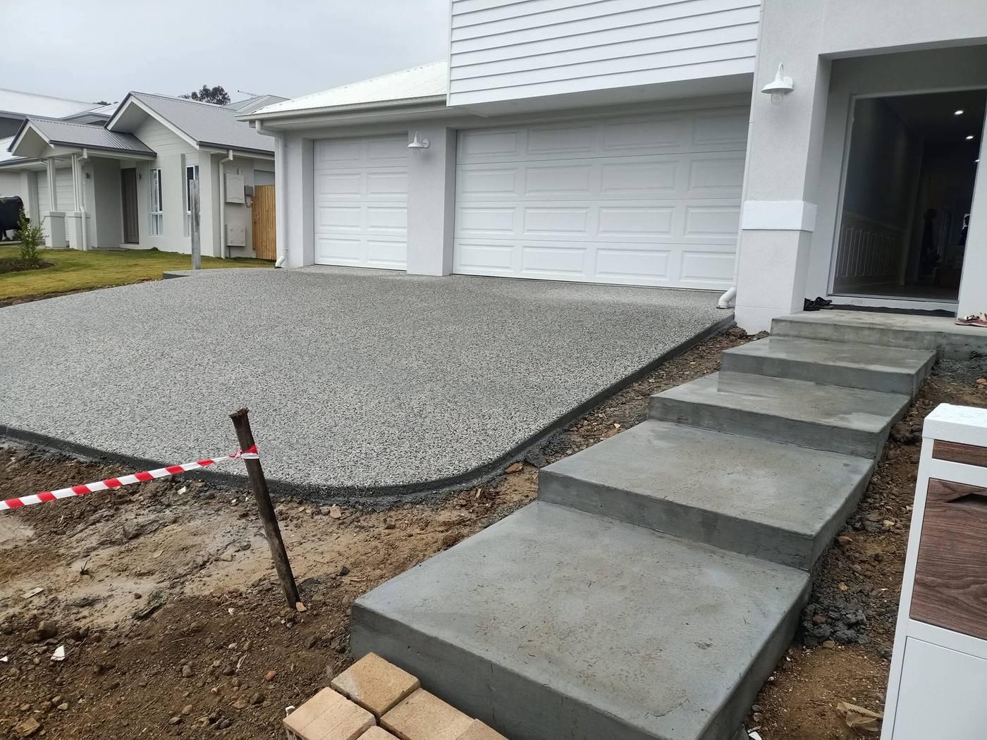 Exposed aggregate driveway with floating concrete steps by JRB